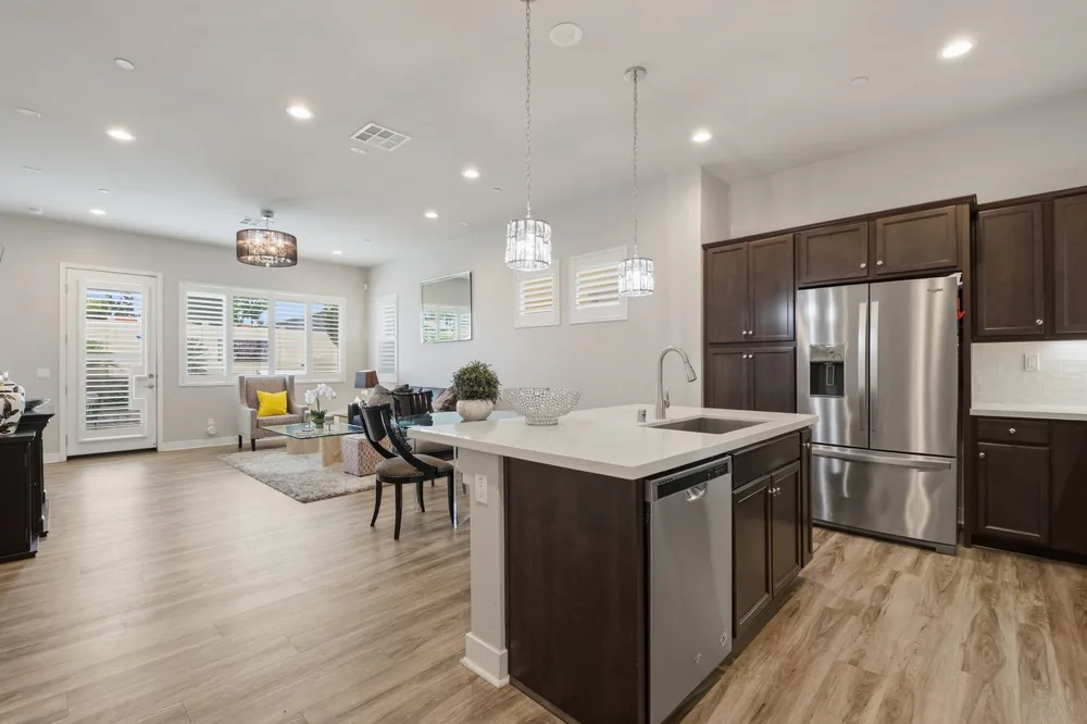 Kitchen with quartz island, stainless appliances, and dark wood cabinetry
