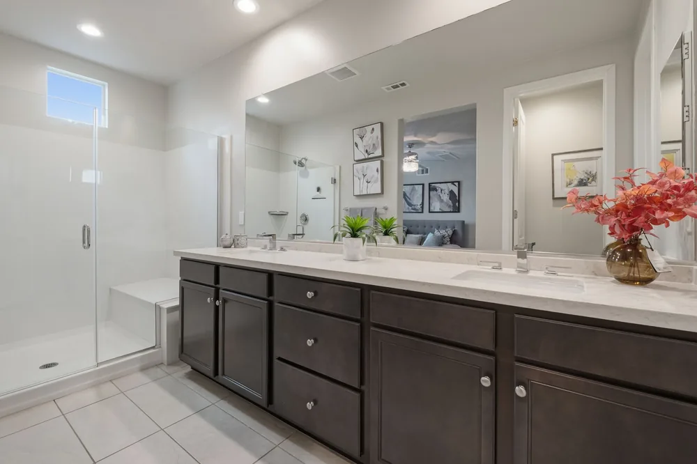 Primary bathroom with dual vanity and glass shower